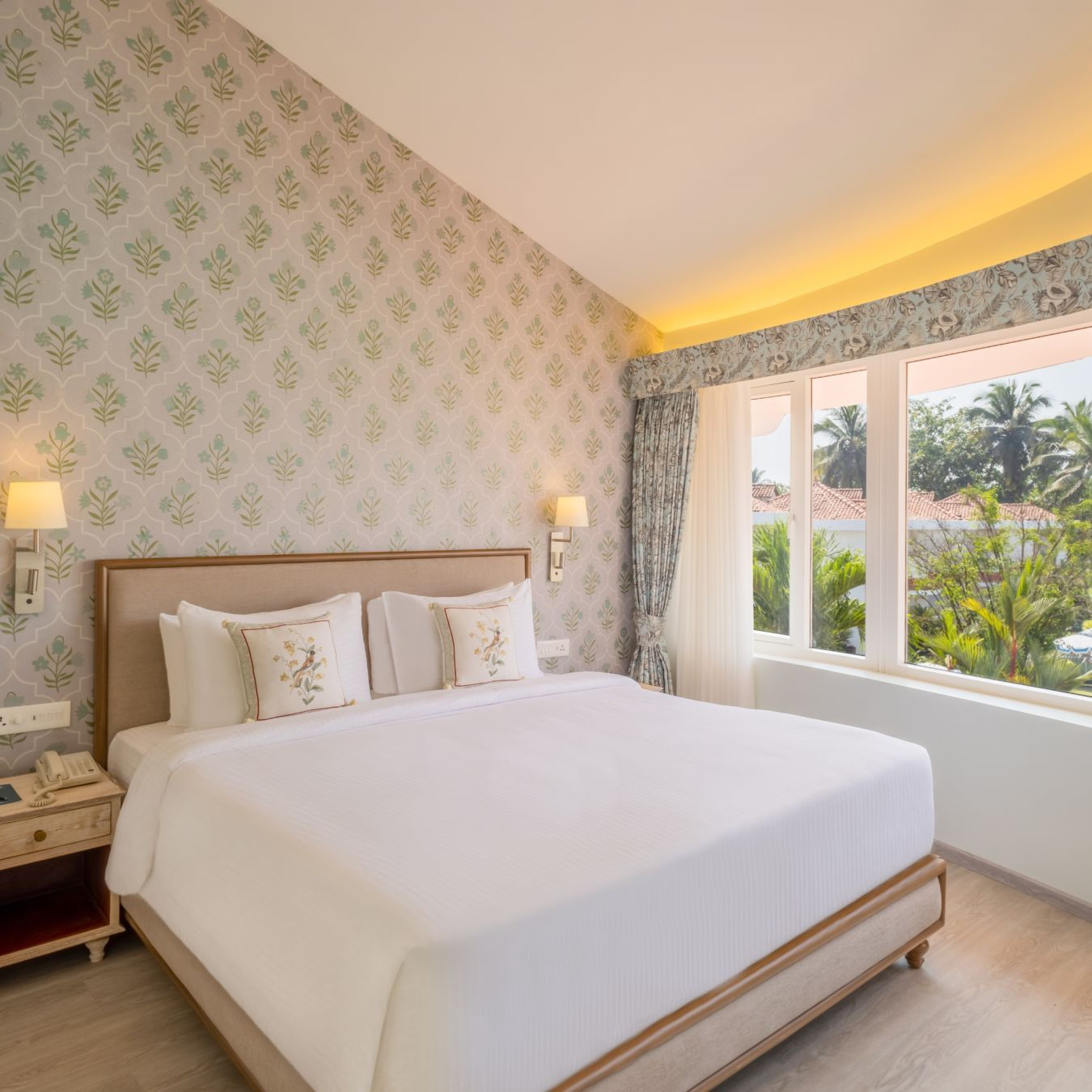 Luxurious suite bedroom at Heritage Village Resorts &amp; Spa, Goa, featuring a king-size bed and elegant decor.