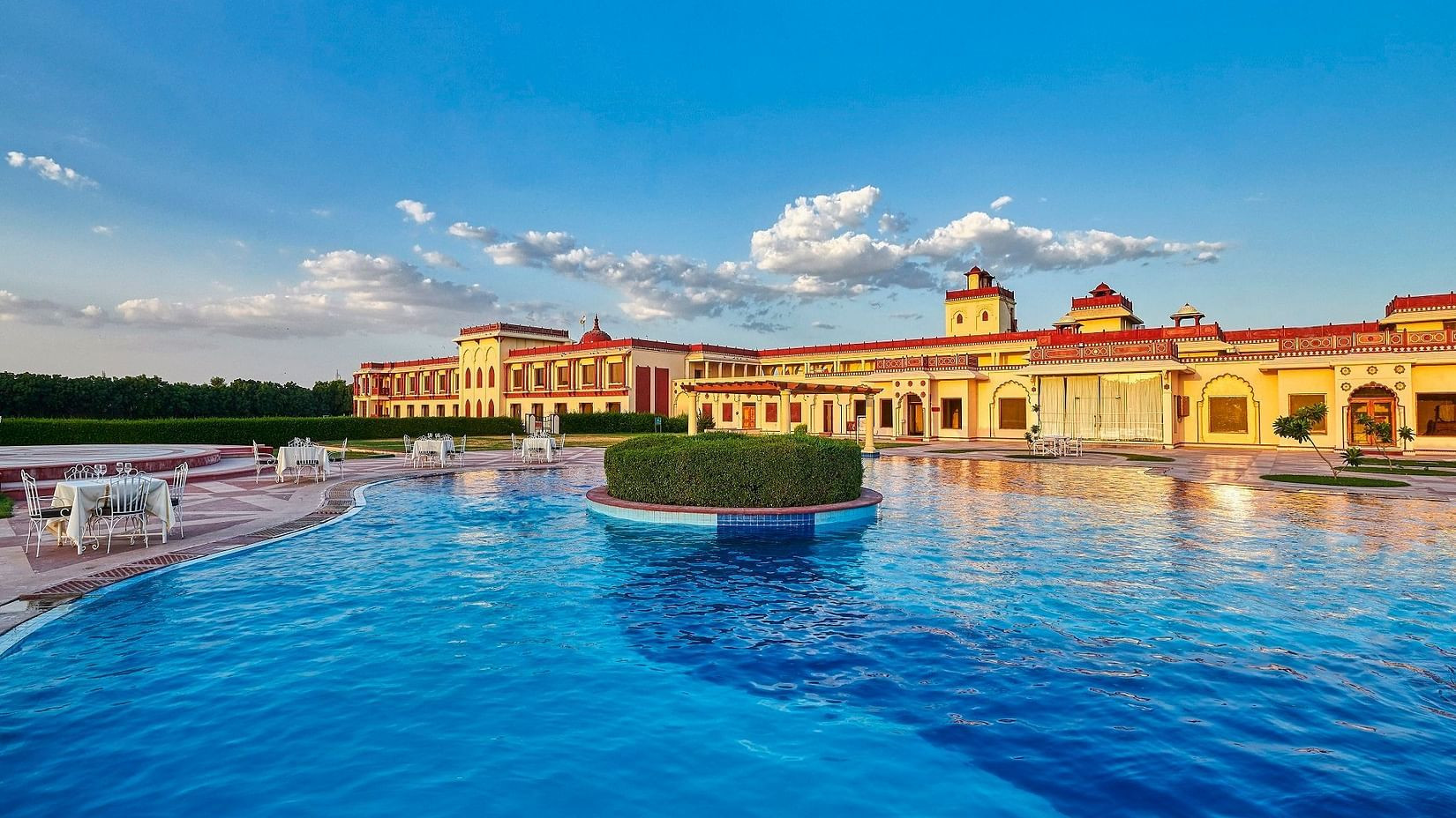 Inviting swimming pool at luxury spa resort in Jodhpur, The Ummed Jodhpur, offering a relaxing pool area for spa guests.