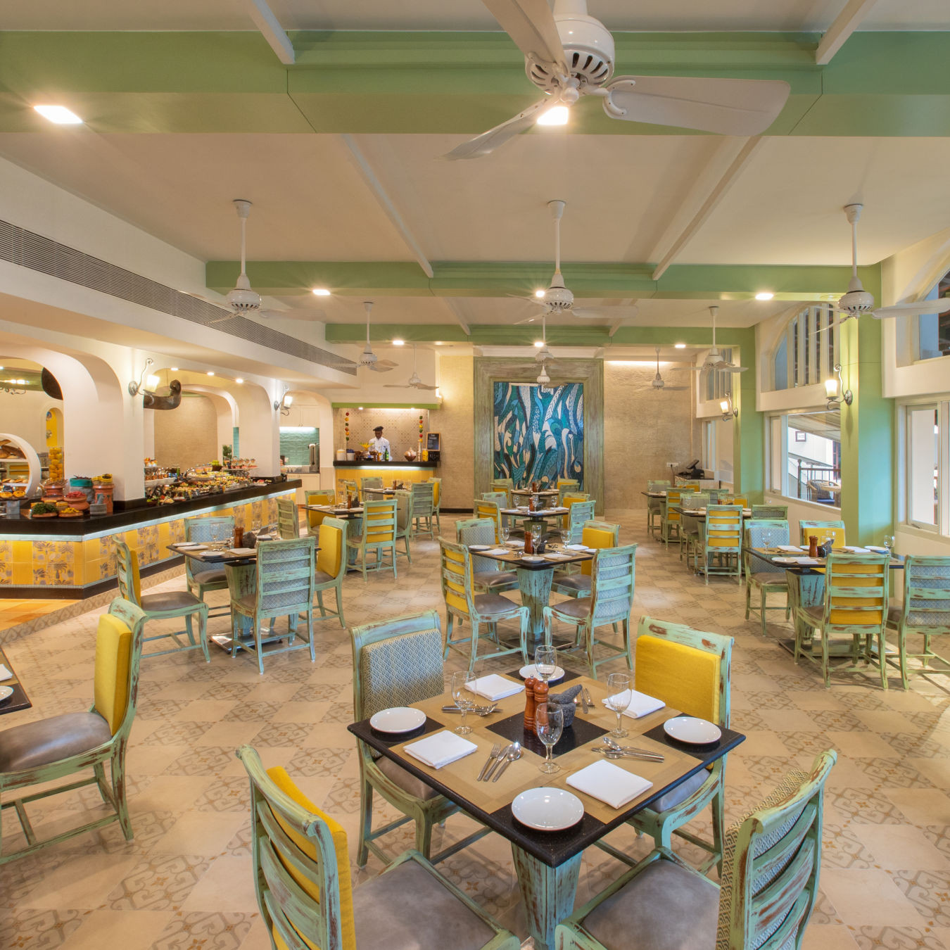 Interior of Chutney restaurant at Heritage Village Goa resort and spa, highlighting its tropical Portuguese design and inviting atmosphere.