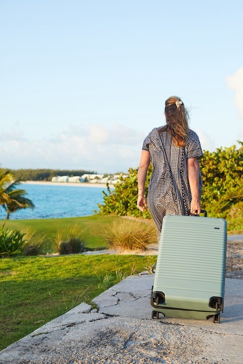 person walking with suitcase