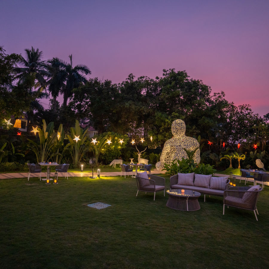 Alfresco dining setup at Heritage Village Resorts &amp; Spa, Goa, offering a delightful outdoor dining experience.