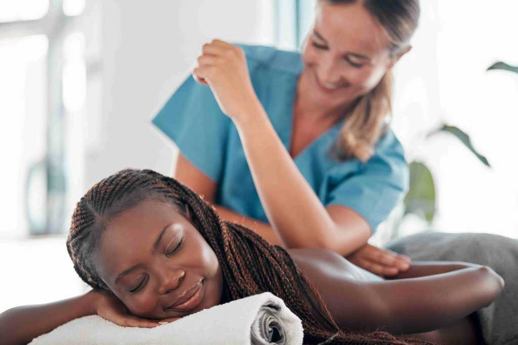 Experience Authentic Thai Massage at a Swedish Thai Spa: A woman enjoying a relaxing back massage session at a spa specializing in Swedish Thai massage therapies.