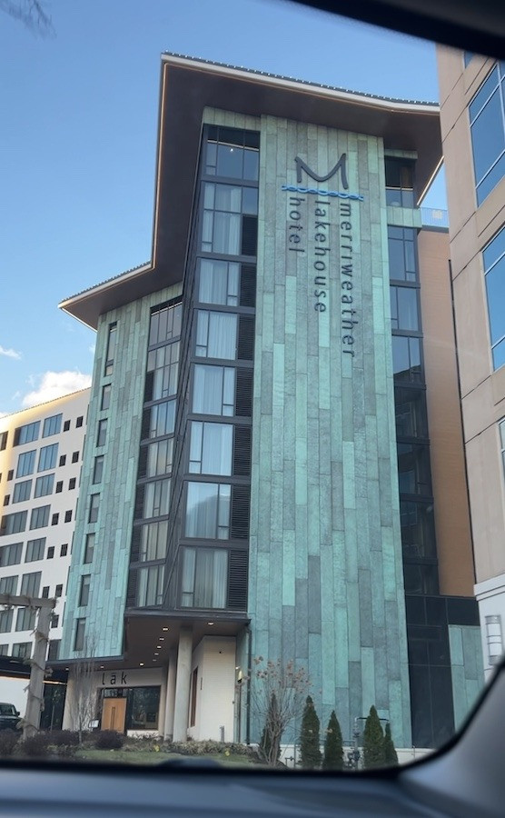 Exterior view of Merriweather Lakehouse Hotel in Columbia Maryland showcasing lakeside location and architectural design, perfect for a relaxing spa getaway.