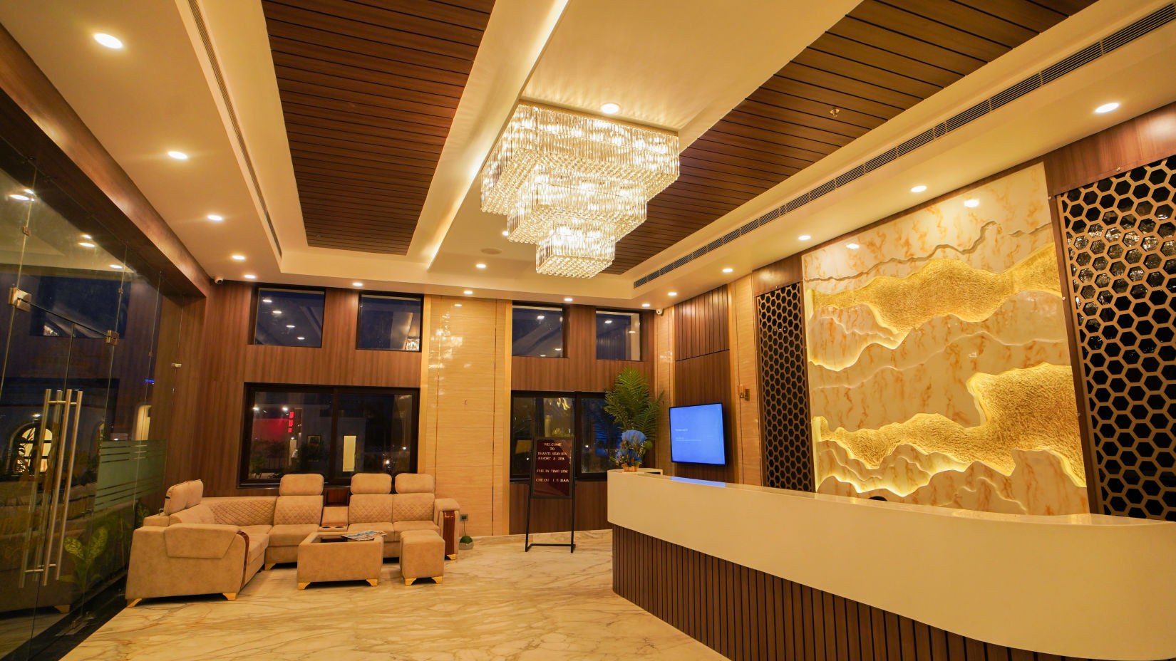 Elegant lobby reception area at Shanti Seaview Resort & Spa in Mandarmani, featuring a chandelier and welcoming atmosphere.