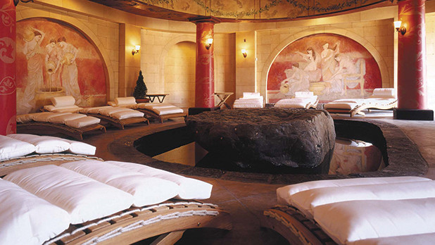 Luxurious spa treatment room with massage table and candles