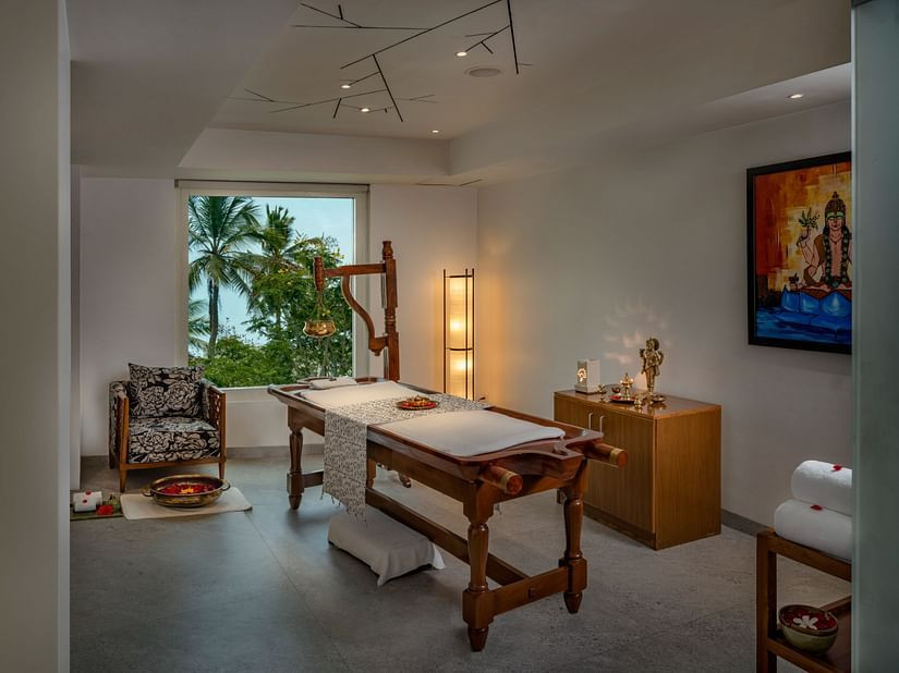 Serene and inviting spa treatment room meticulously prepared for a rejuvenating massage session at a top-rated spa in Trivandrum.