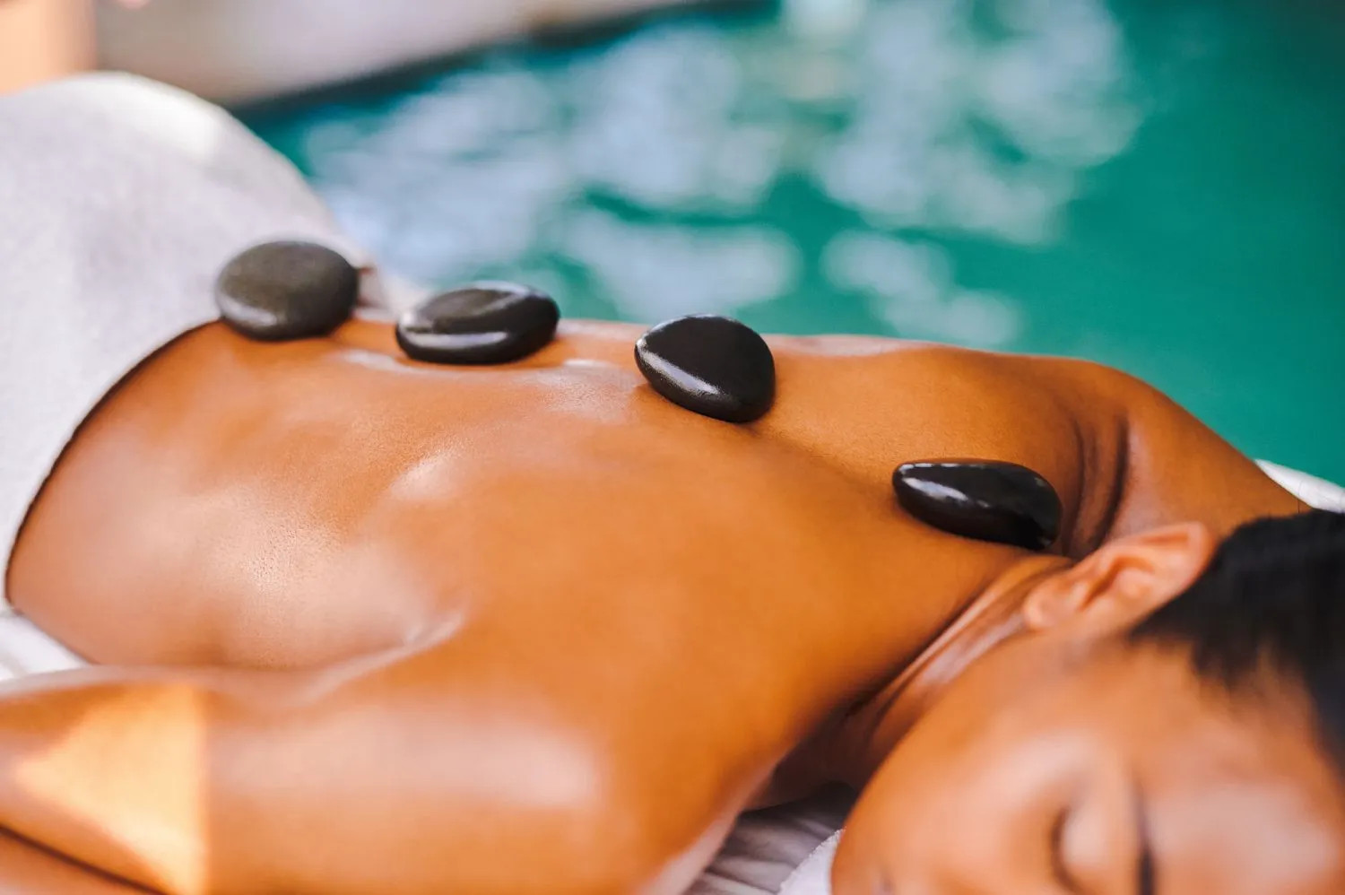 Hot stone massage therapy for male clients at Jaipur spa.