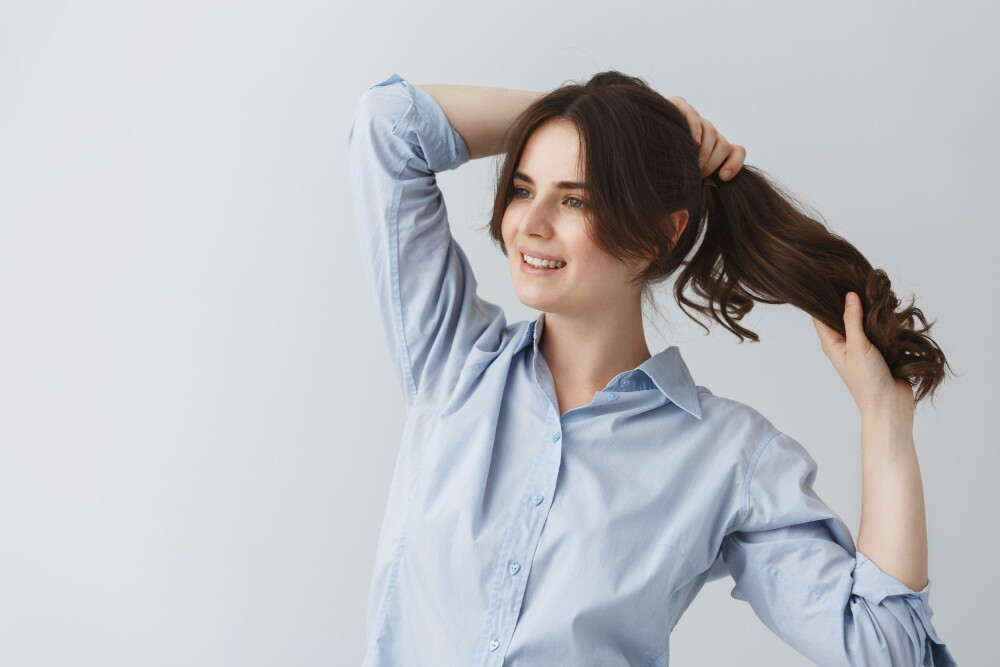 Happy woman with styled hair, showcasing the benefits of hair spa for hair health