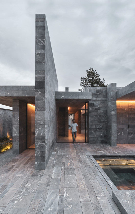 Exterior nighttime view of the Spa Pavilion with ambient lighting and natural stone