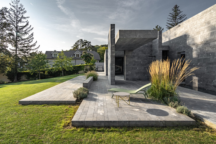 Front exterior view of the Spa Pavilion showcasing the stone slabs and landscaping