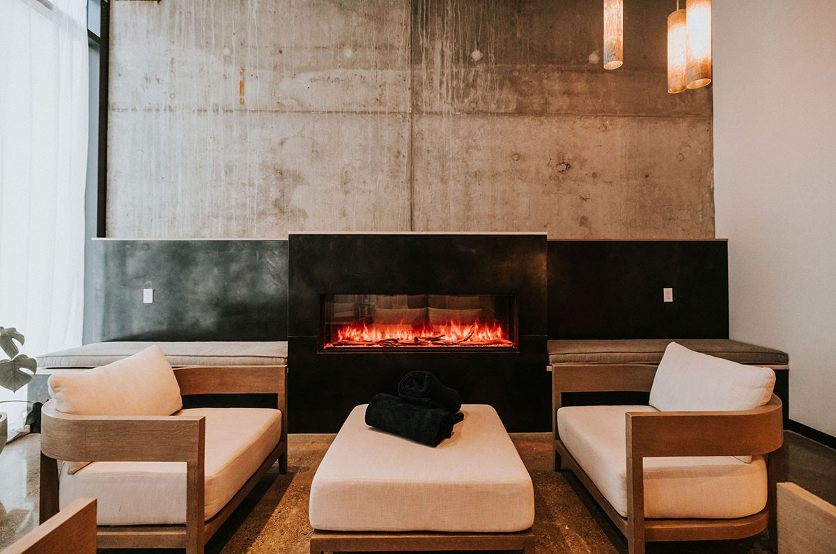 Spa waiting room with a fireplace and lounge chairs