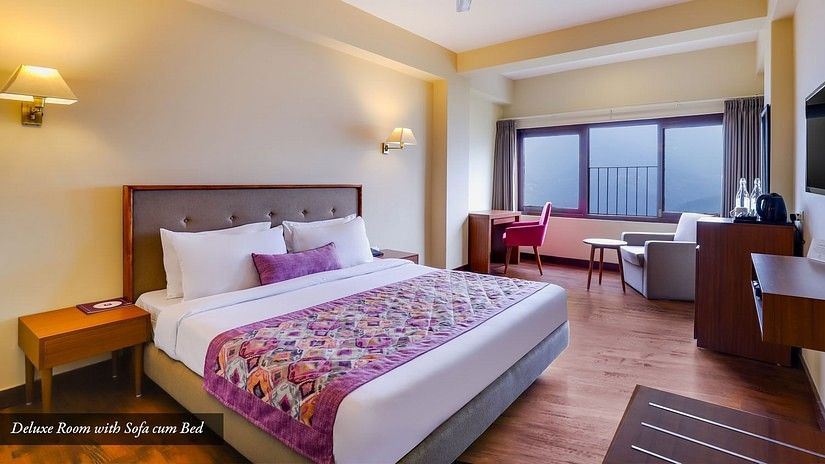 Deluxe Room at Mount Himalayan Hotel & Spa, Gangtok. Enjoy a comfortable stay with a sofa cum bed and modern amenities
