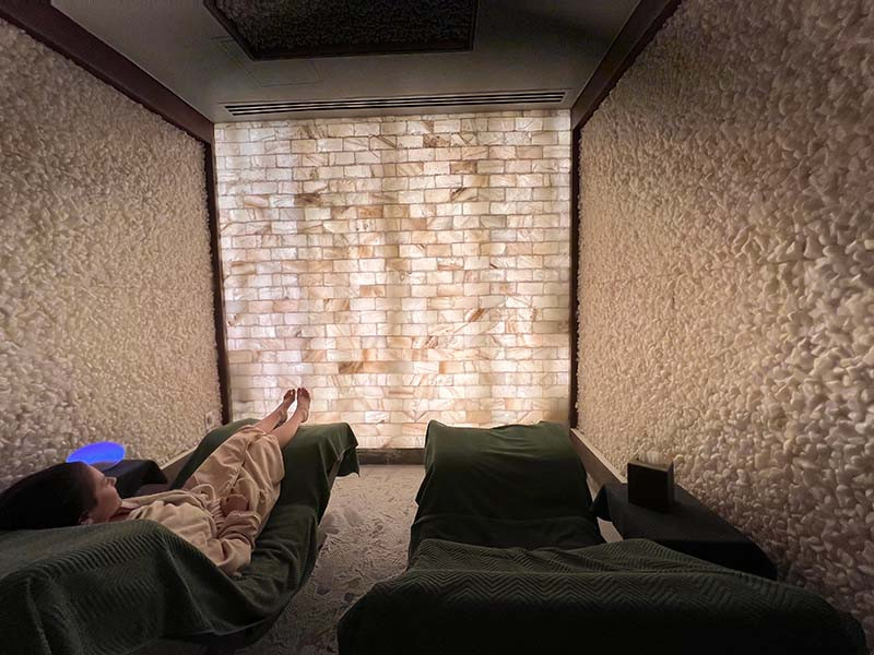 Himalayan Salt Room at Spa Avania with comfortable loungers and backlit salt walls