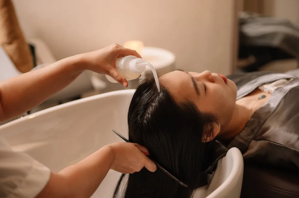 Woman in a plush spa robe, relaxing in a visually calming environment, enhancing her sight and sense of relaxation